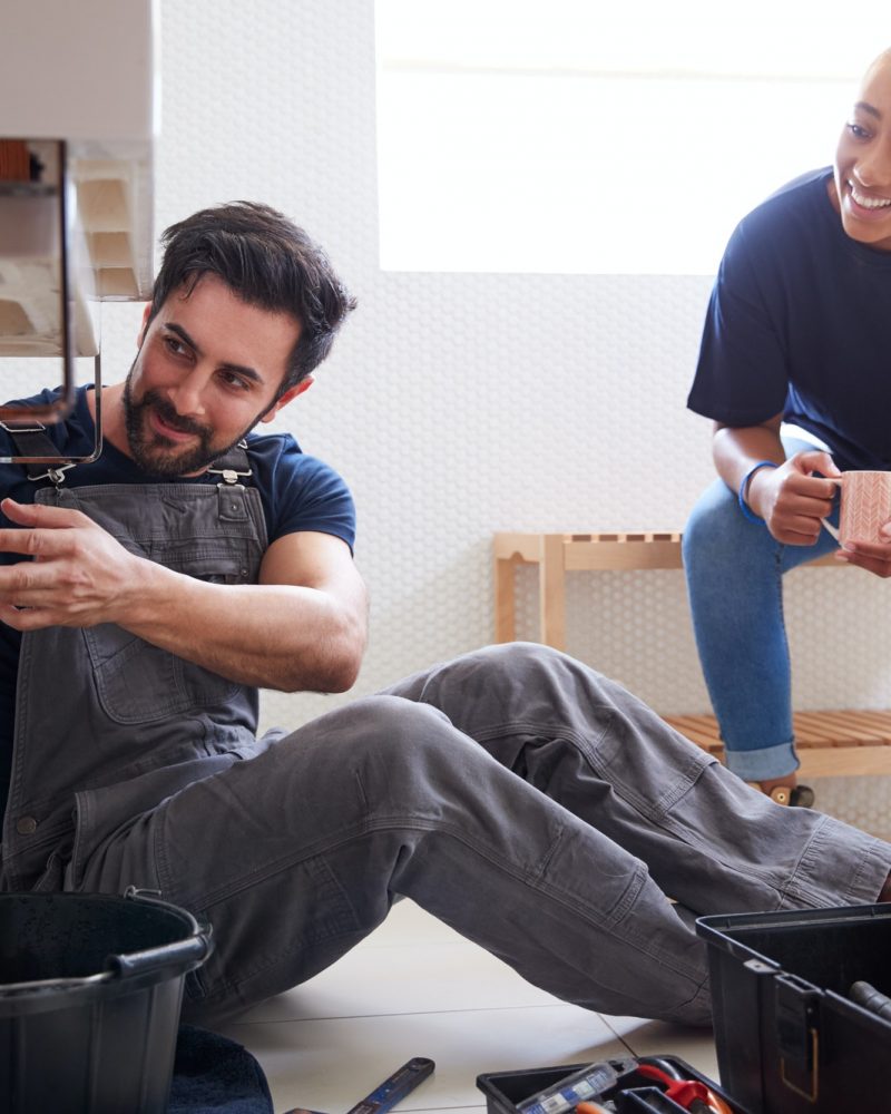 male-plumber-teaching-female-apprentice-to-fix-leaking-sink-in-home-bathroom.jpg